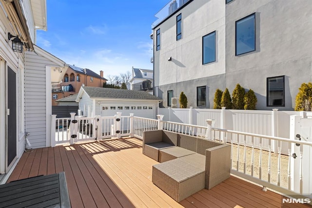 wooden deck featuring an outbuilding, outdoor lounge area, fence, and a residential view