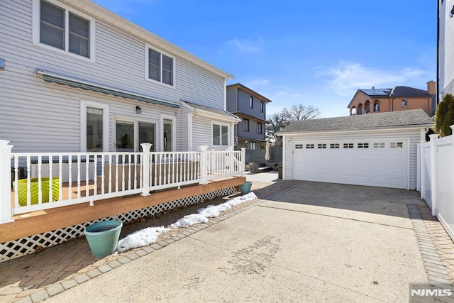 view of front of home with a deck, an outdoor structure, and a garage