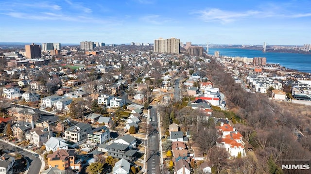 birds eye view of property with a water view and a city view