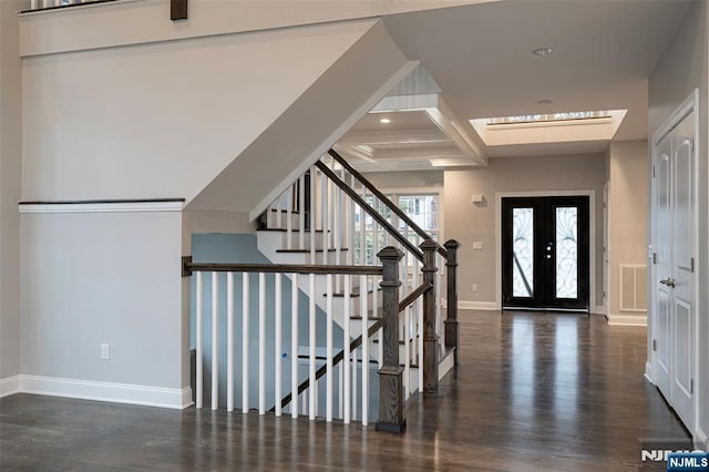 entrance foyer with french doors, coffered ceiling, dark hardwood / wood-style floors, and beamed ceiling