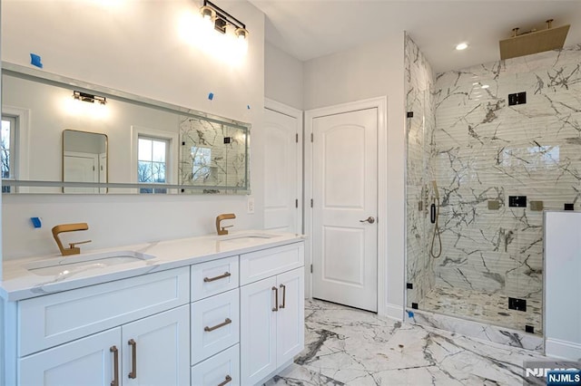 bathroom with vanity and a shower with door