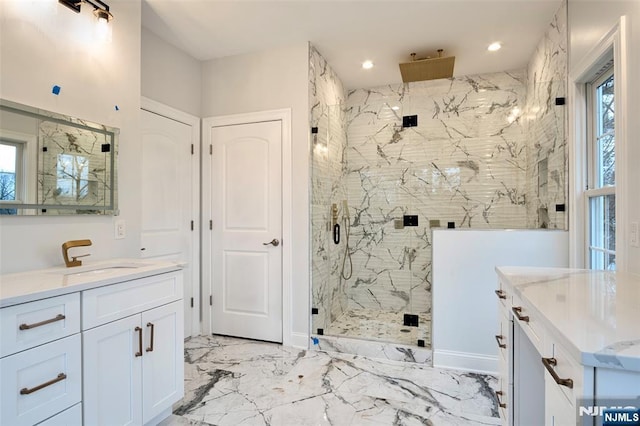 bathroom with vanity and a shower with shower door