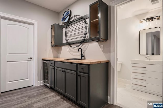 interior space featuring vanity, wood-type flooring, and beverage cooler