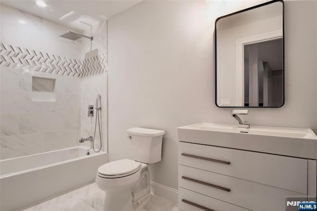 full bathroom featuring tiled shower / bath, vanity, and toilet