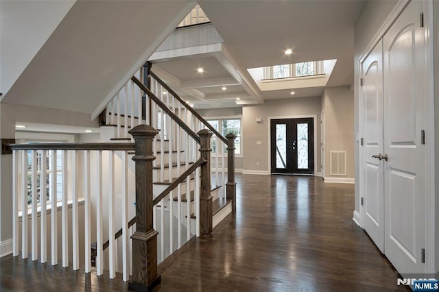 entrance foyer with french doors, coffered ceiling, dark hardwood / wood-style floors, and beam ceiling