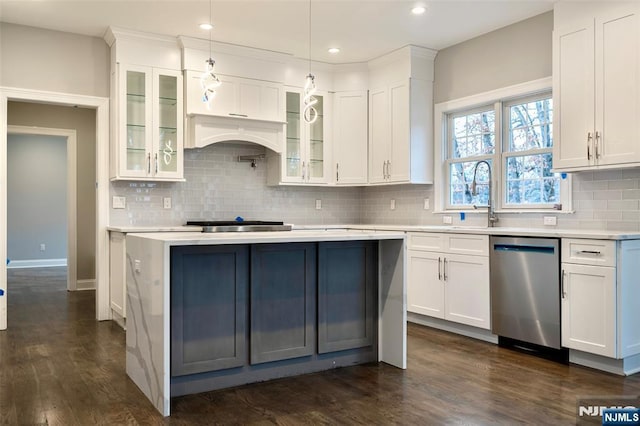 kitchen featuring decorative light fixtures, white cabinetry, decorative backsplash, stainless steel dishwasher, and dark wood-type flooring