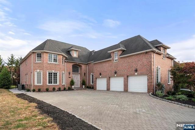 view of property with a garage and central AC