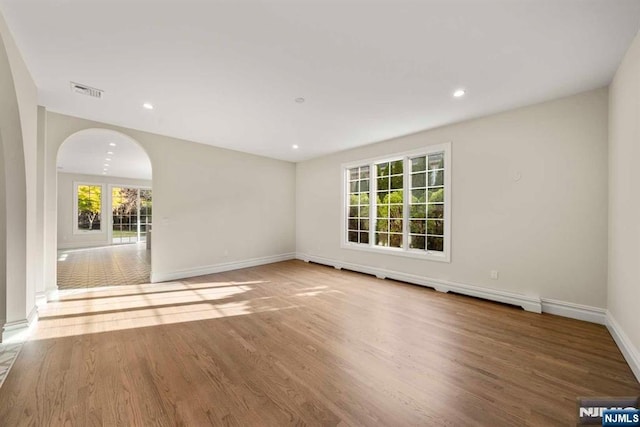 empty room with light hardwood / wood-style flooring