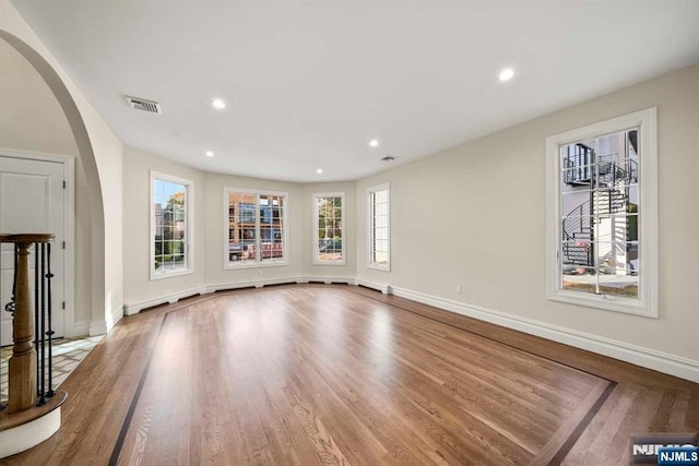 unfurnished living room with hardwood / wood-style flooring