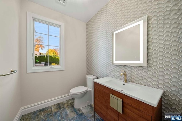 bathroom with vanity and toilet