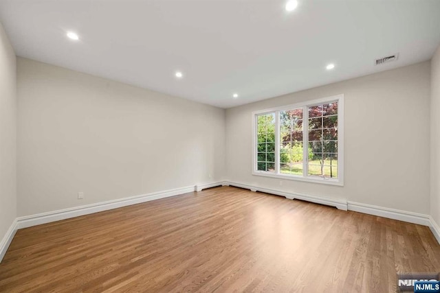 spare room featuring light hardwood / wood-style flooring