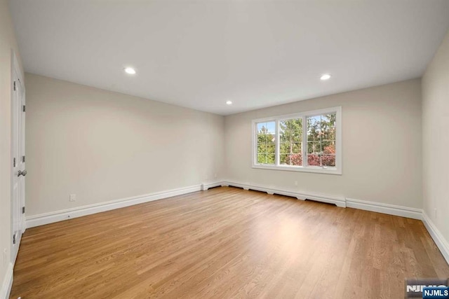 unfurnished room with light wood-type flooring