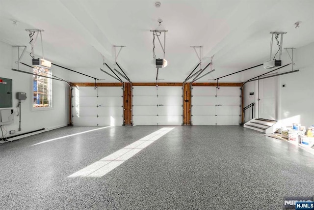 garage featuring a garage door opener and electric panel