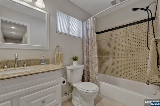 full bathroom with shower / tub combo with curtain, vanity, and toilet