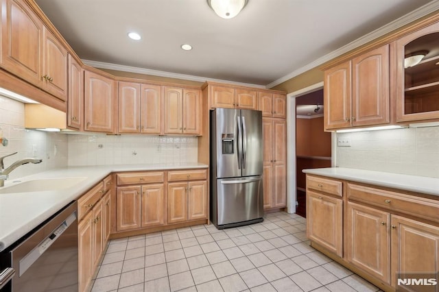 kitchen with crown molding, stainless steel appliances, light countertops, backsplash, and a sink