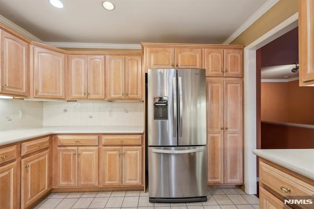 kitchen with crown molding, light countertops, backsplash, light tile patterned flooring, and stainless steel fridge with ice dispenser