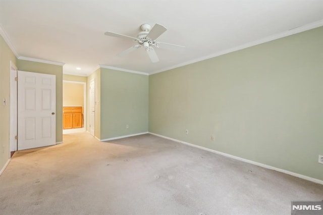 unfurnished bedroom featuring carpet floors, ornamental molding, a ceiling fan, and baseboards