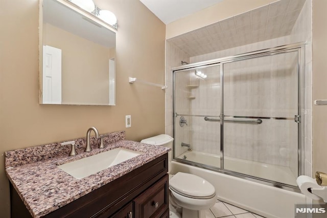 full bath featuring toilet, tile patterned floors, enclosed tub / shower combo, and vanity