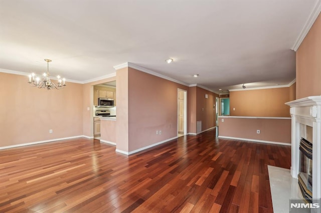 unfurnished living room with crown molding, a fireplace with flush hearth, hardwood / wood-style flooring, and a notable chandelier