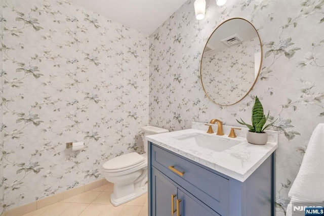 bathroom featuring toilet, tile patterned floors, and vanity