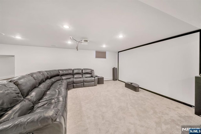 home theater room with light colored carpet