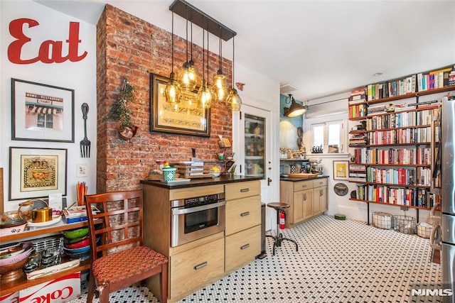 kitchen featuring stainless steel oven and decorative light fixtures