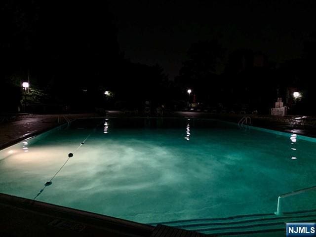 view of pool at night