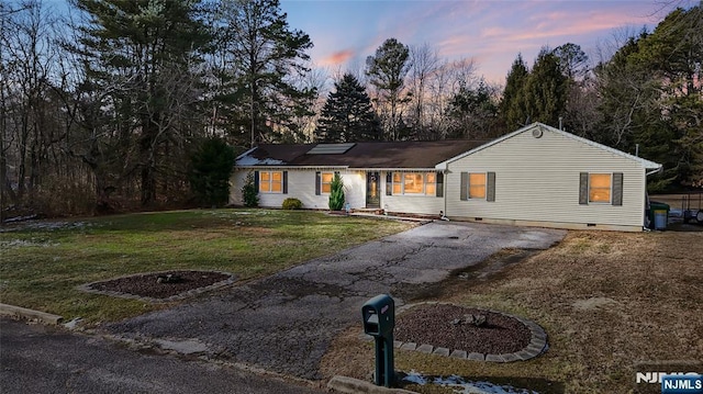 ranch-style house featuring a yard