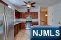 kitchen with ceiling fan and stainless steel fridge with ice dispenser