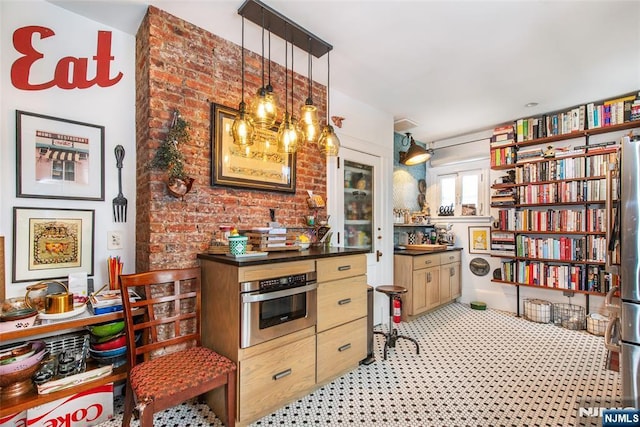 kitchen featuring hanging light fixtures, dark countertops, and oven