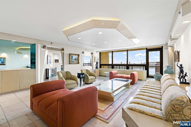 tiled living room featuring a wall of windows