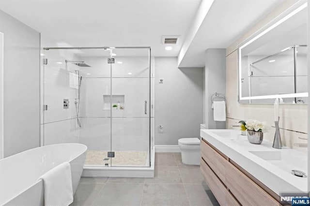 full bathroom with vanity, toilet, tile patterned floors, and plus walk in shower