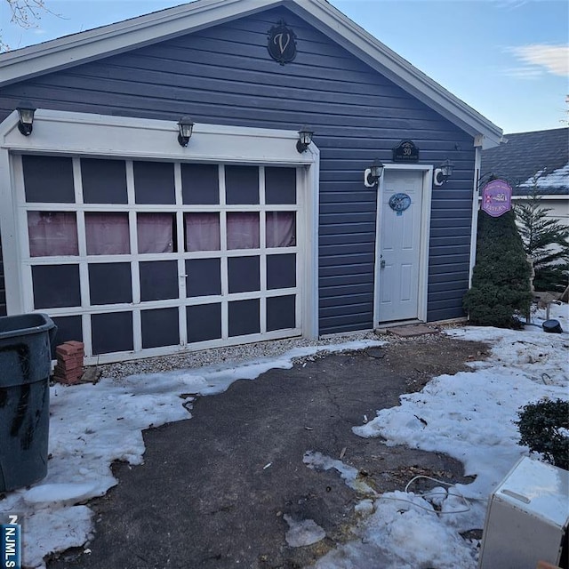 view of front of home with a garage and an outdoor structure