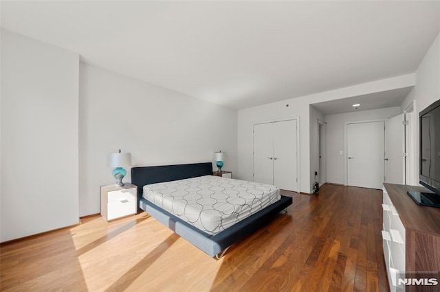 bedroom featuring wood finished floors and a closet