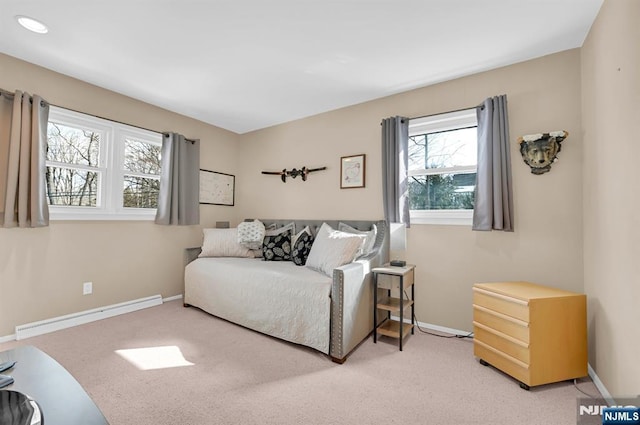 living area featuring baseboards, baseboard heating, and carpet flooring