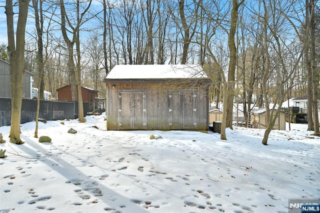 exterior space featuring fence and an outbuilding