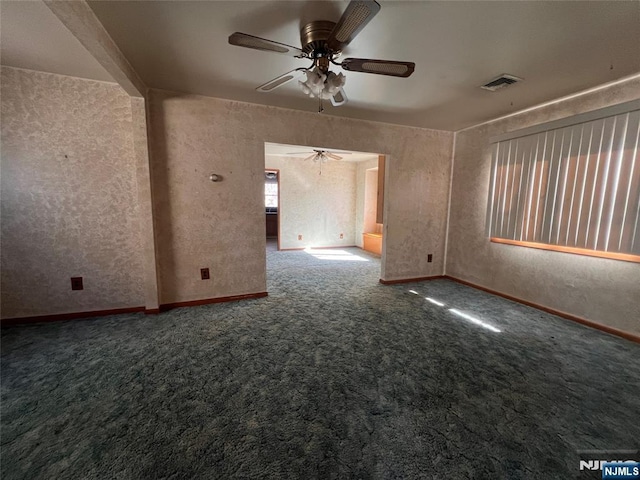 spare room featuring ceiling fan and carpet flooring