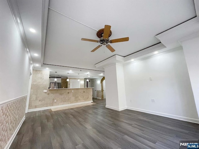 unfurnished living room with ceiling fan, crown molding, and dark hardwood / wood-style flooring