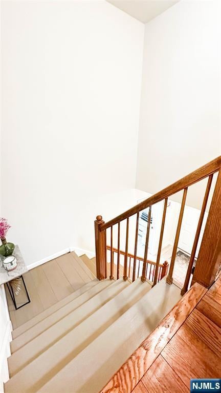 stairs featuring wood-type flooring