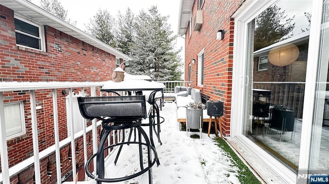 view of snow covered back of property