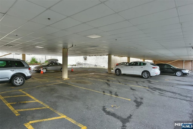 view of parking / parking lot featuring a carport