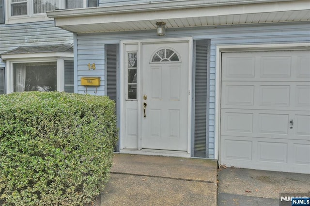 view of exterior entry featuring a garage