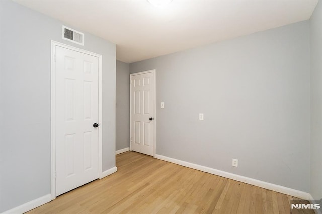 unfurnished room featuring light hardwood / wood-style floors