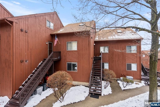 snow covered property featuring cooling unit