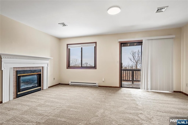 unfurnished living room featuring carpet flooring, plenty of natural light, a tile fireplace, and baseboard heating