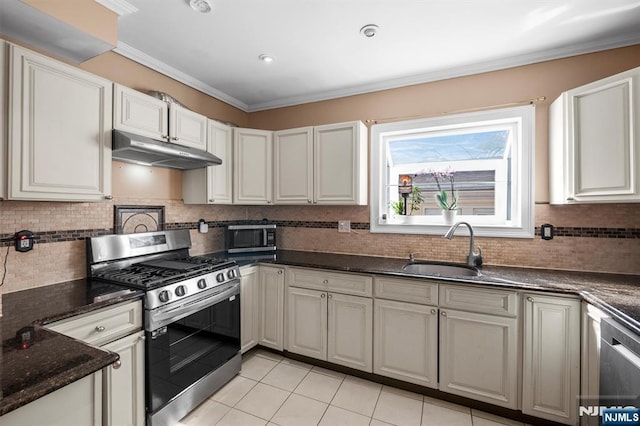 kitchen with appliances with stainless steel finishes, sink, and white cabinetry