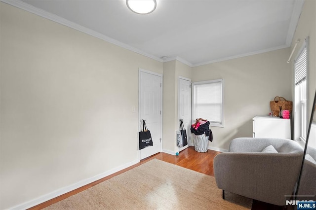 sitting room featuring crown molding and wood-type flooring