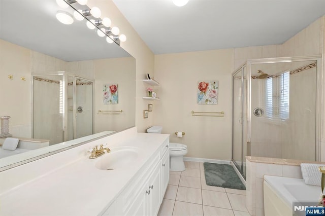 full bathroom featuring toilet, vanity, baseboards, a shower stall, and tile patterned floors