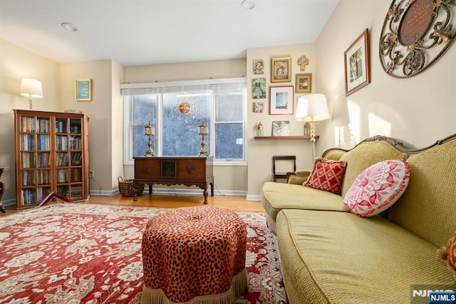 living area with light wood-style floors and baseboards