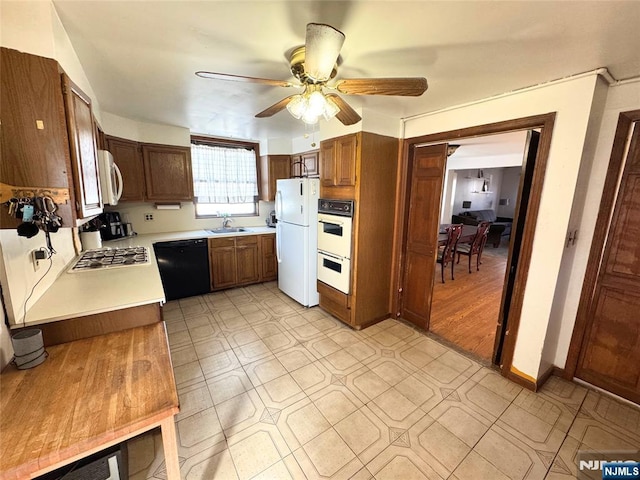 kitchen with sink, white appliances, and ceiling fan